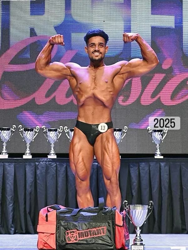 Jatin Sharma flexing on stage during 2025 show win